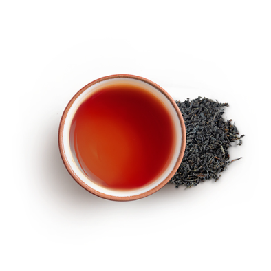 Cup of black tea with tea leaves
