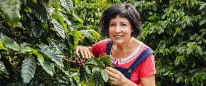 Rebecca Zentveld standing by her coffee trees